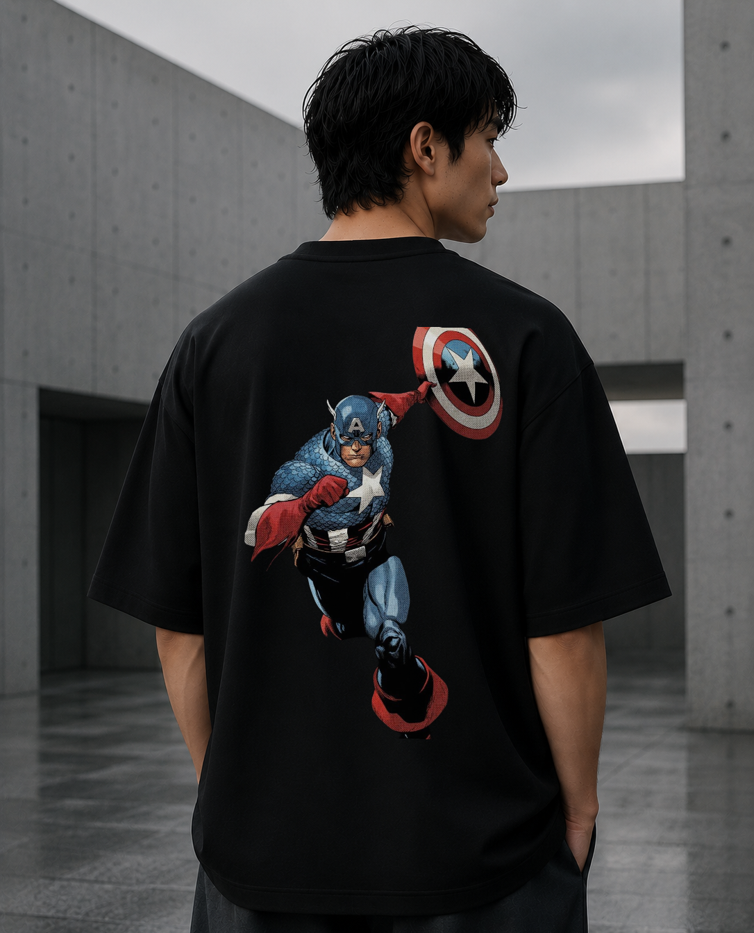 Model wearing black oversized graphic t-shirt with Valor Shield artwork on the back